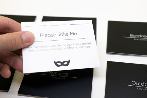 kinky game by joyful couple, activity card held in hand, close up