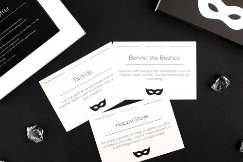 kinky game by joyful couple, activity cards in close up