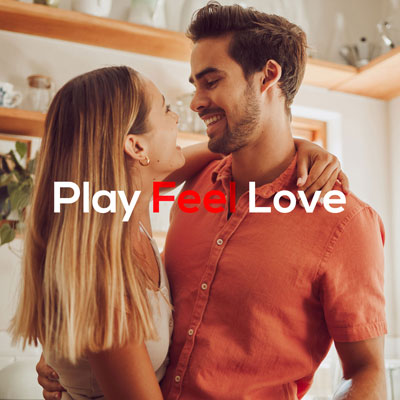 cute, loving couple looking at each other and smiling, they are in their kitchen, warm tones