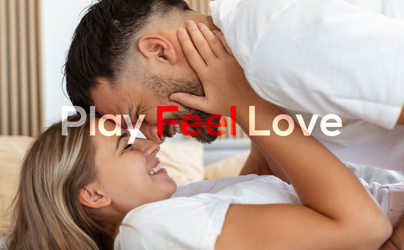 loving playful couple lying in bed, both are smiling an happy