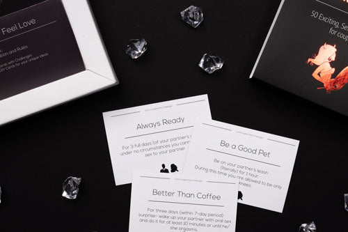 kinky challenges by joyful couple, close up of the activities cards, black background