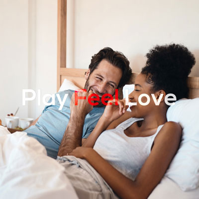 loving couple laying in be and having a heartfelt conversation, both are smiling and having fun
