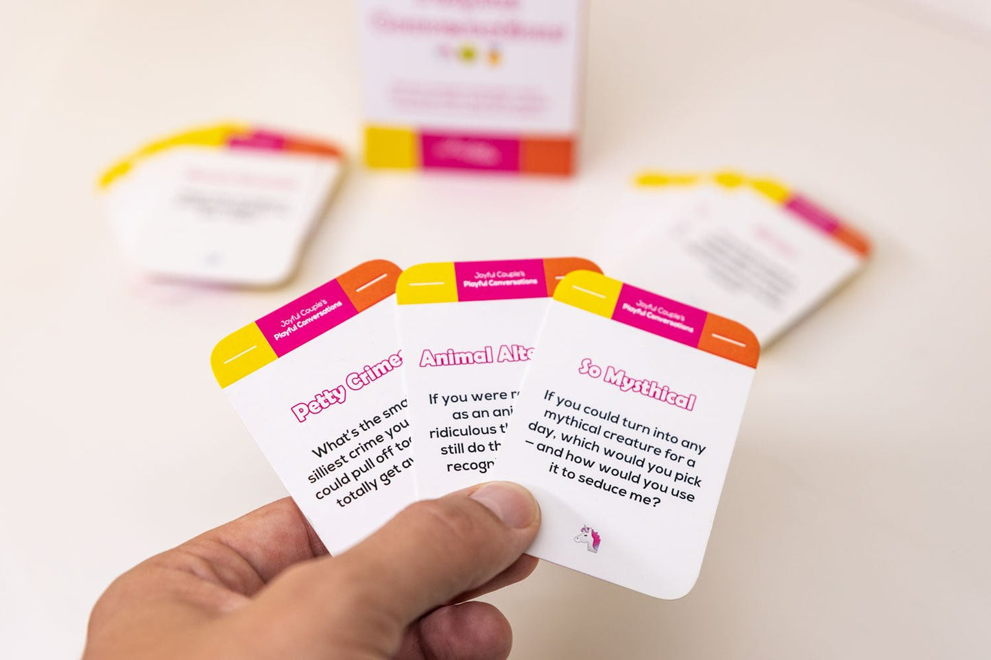 playful conversations by joyful couple, an unserious conversation starter for couples and close friends, some example cards in the hand
